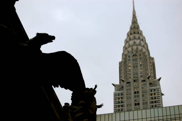 Grand Central Eagle Silhouette by Chrysler Building in New York City New York City, NY/USA - October 30, 2009 - Grand Central cast-iron eagle silhouette looms in front of the Chrysler Building in New York City. chrysler building eagles stock pictures, royalty-free photos & images