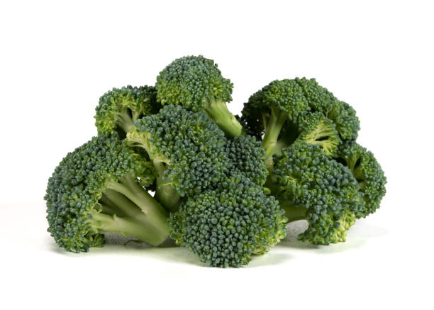 Large Pile of Broccoli Large Pile of Broccoli on White Background broccoli crowns stock pictures, royalty-free photos & images