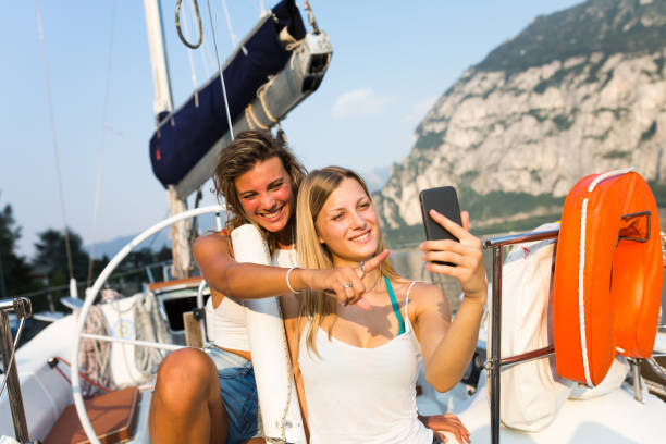 istock Young women take a selfy on sailboat 971610350