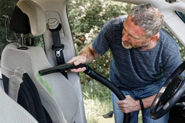 istock Man hoovering a seat in car 971624008