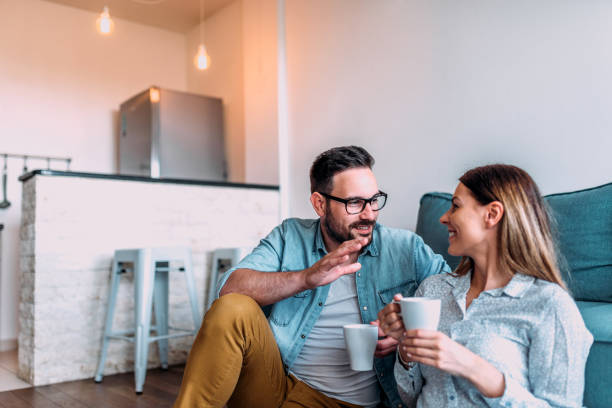 istock Cute couple having coffee and talking indoors. 971630442