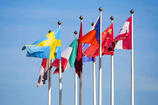 istock Flags of different countries flutters in the wind against a light blue sky 971648980