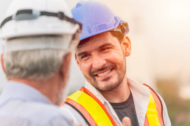 istock smiling engineer happy to working together talking with business man 971659328