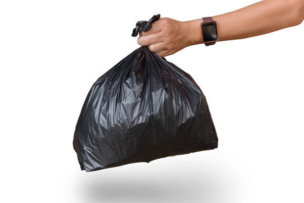 istock man hand holding garbage bag isolated on white with clipping path 971662790