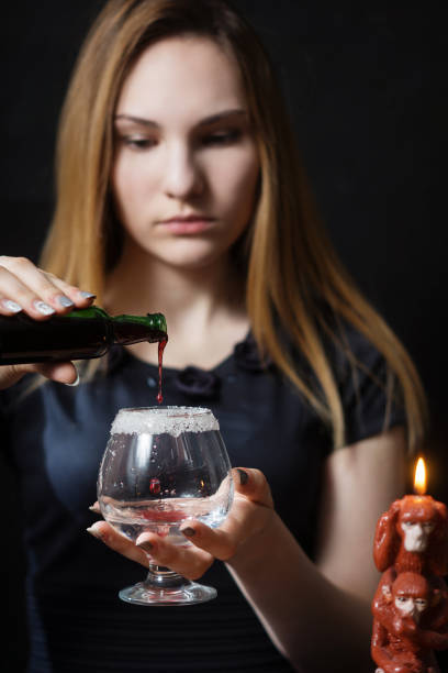 A young girl prepares a hot cocktail of gin
