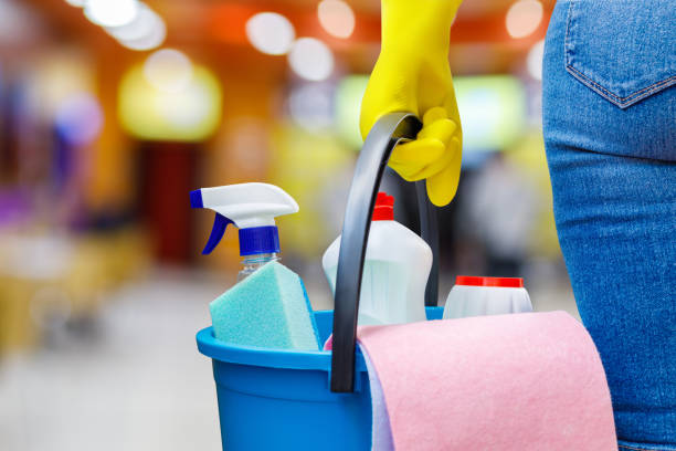istock Cleaning lady standing with a bucket and detergents . 971667056