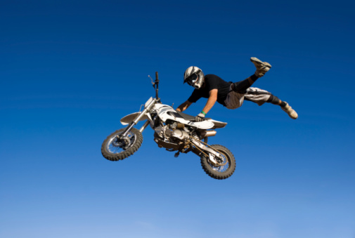 Cycling jump, sports or mountain bike man with air trick for fun, exercise or training for speed travel race. Dirt ramp, bicycle nature flight or extreme athlete with freestyle action