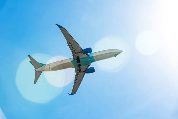 istock Passenger plane flying in the blue sky in sunlight rays 971679018