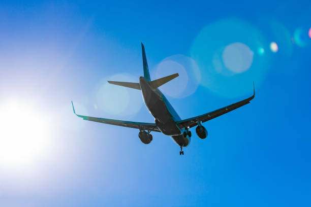 istock Passenger plane flying in the blue sky in sunlight rays 971679286
