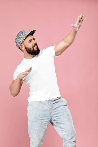 bearded man in cap dancing portrait of handsome bearded man in cap dancing rap kid stock pictures, royalty-free photos & images