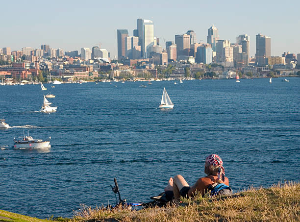Bicyclist with bandana looking at lake and Seattle stock photo