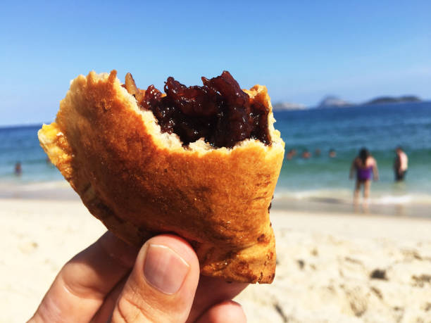 istock Hand Holding Banana Pastry at the Beach 971686038