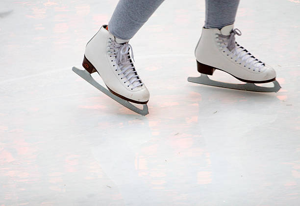 Feet of figure skater on ice stock photo