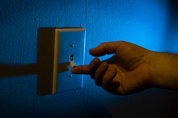 Turning on the light switch stock photo