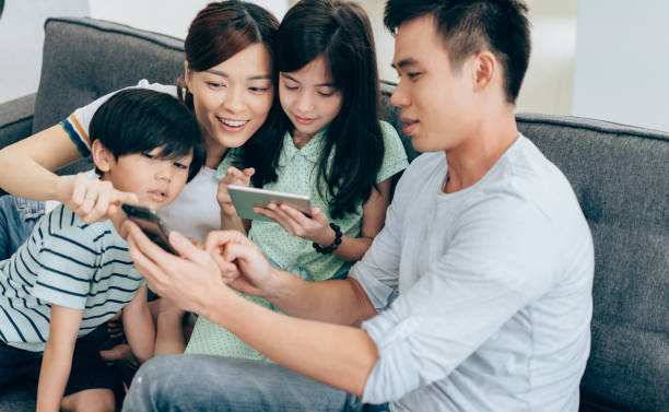 istock Young family have fun with digital devices 971689116