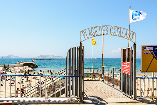 Marseille, France - May 19, 2018: View of the entrance gateway of the Catalans beach, the most popular and frequented beach in Marseille, situated only 15 minutes walk from the city center.