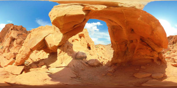 Young Caucasian woman standing near natural stone bridge in Wadi Rum desert