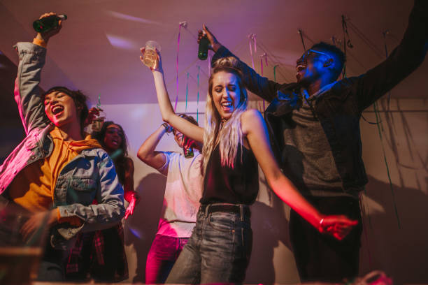 istock Friends dancing at a house party 971701354