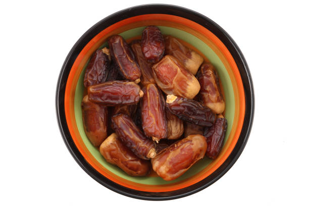 istock Bowl of pitted dates isolated on white background, top view 971703470
