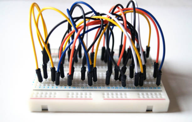 istock Wires pluged in to a breadbaord. 971703948