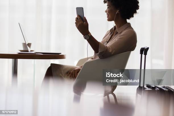 Woman At Airport Lounge Making Video Call Stock Photo - Download Image Now - Airport Departure Area, Airport VIP Lounge, Business Travel