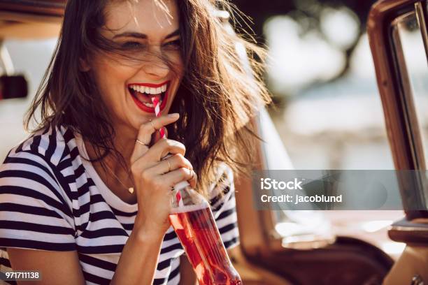 Woman In Car Enjoying Drinking Cola Stock Photo - Download Image Now - Drinking, Women, Summer