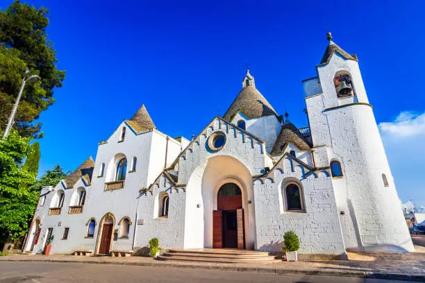 Alberobello, Puglia, Italy: The Church of St. Antonio built with trullo conical roofs, in a beautiful day, Apulia