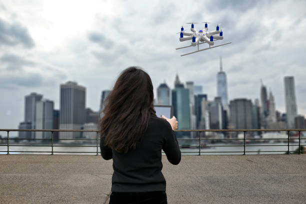 Young women using a drone over the city