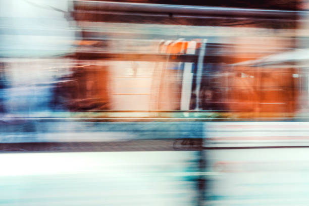 A bus moves swiftly through the urban landscape of Berlin at night, creating a dreamy, ghostly atmosphere with motion blur.