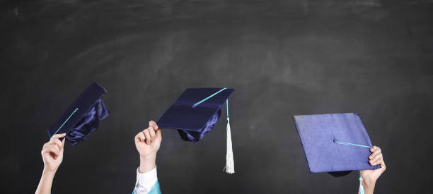 istock Graduates holding motarboards 971763010
