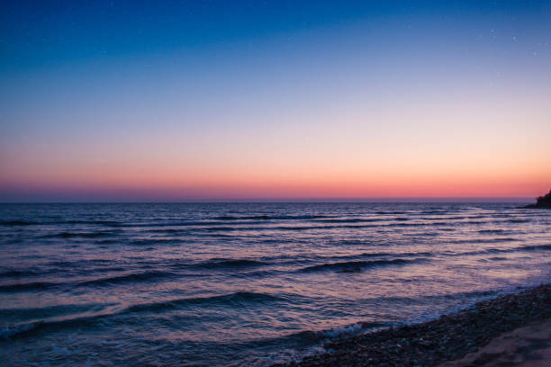 istock Magical sunset on the beach with the view on the young moon. 971766534