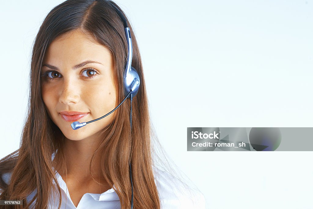 Close-up of female call center operator with head set on Young beautiful woman with headset on light blue background Various Occupations Stock Photo