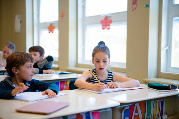 istock Multi-ethnic students sit into the class for the first day at school 971804444