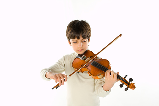 Little boy aged 9 playing violin. A note stand is in front of him.\nNikon D850