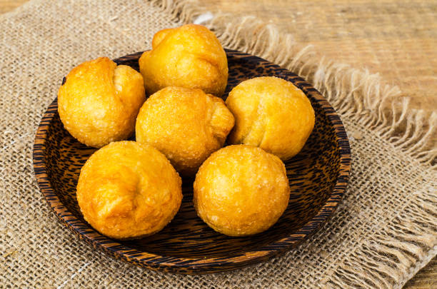 istock Round sweet curd donuts on wooden plate 971818338