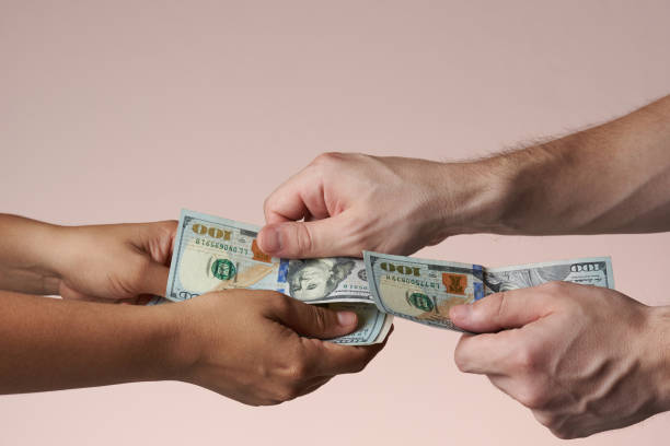 istock One hand put hundred dollar bill 971819754