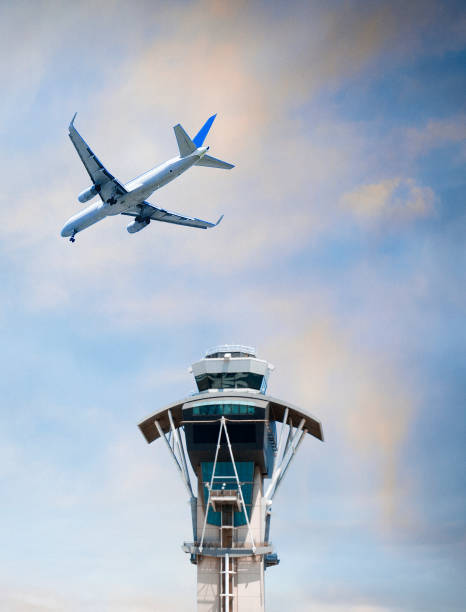 istock Airplane flying over air traffic control tower 971829884