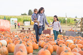 Beautiful ethnic mom and her daughters at the pumpkin farm!
