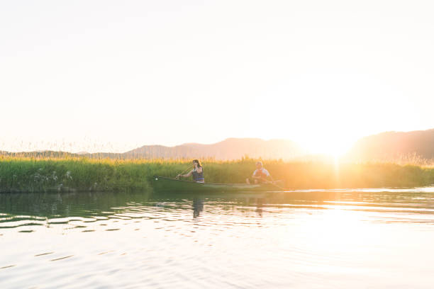 istock Senior couple canoeing together on a summer evening 971843464