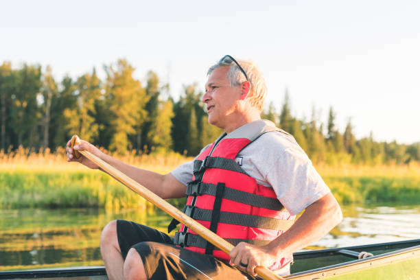 istock Senior man canoeing on a beautiful Idaho lake 971843468