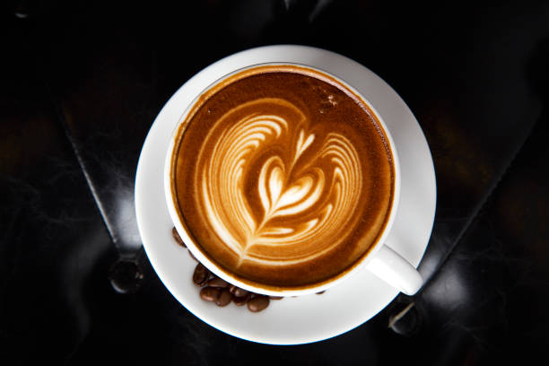 istock Coffee latte art with Leather sofa background 971846468