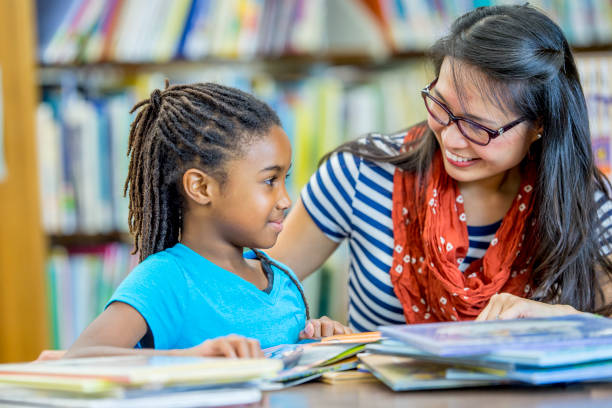 istock Librarian Talking To Girl 971866516