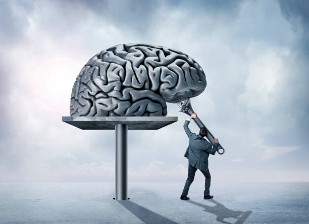 istock Man Uses Large Wrench To Adjust Brain Above Him 971867214