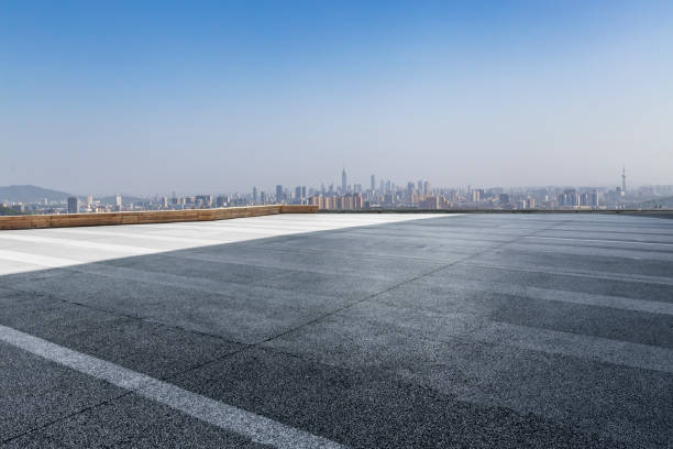 istock Panoramic skyline and modern business office buildings with empty road,empty concrete square floor 971879894