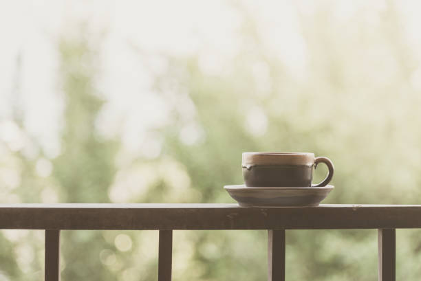 istock Close-Up Of Coffee Cup On Railing 971883634