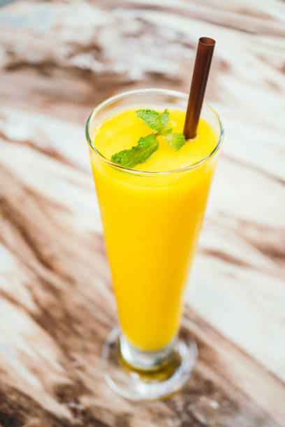 istock Close-Up Of Yellow Drink On Table 971884356
