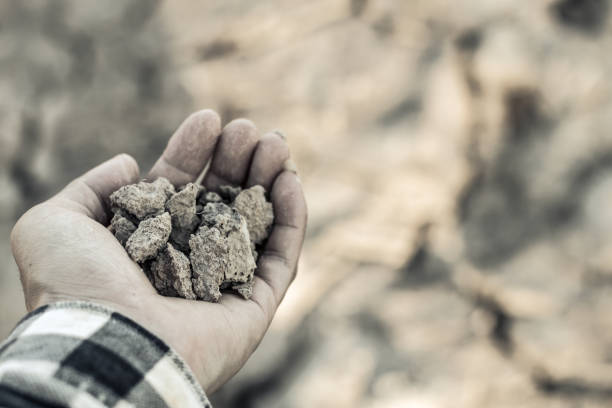 istock Cropped Hand Holding Rocks 971898476