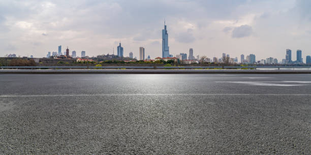 istock Panoramic skyline and modern business office buildings with empty road,empty concrete square floor 971914900