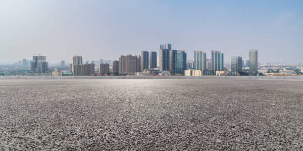 istock Panoramic skyline and modern business office buildings with empty road,empty concrete square floor 971919384