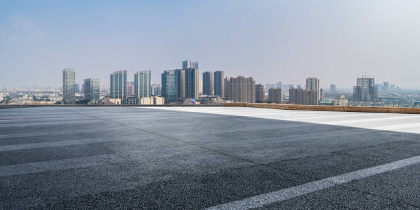 istock Panoramic skyline and modern business office buildings with empty road,empty concrete square floor 971919430